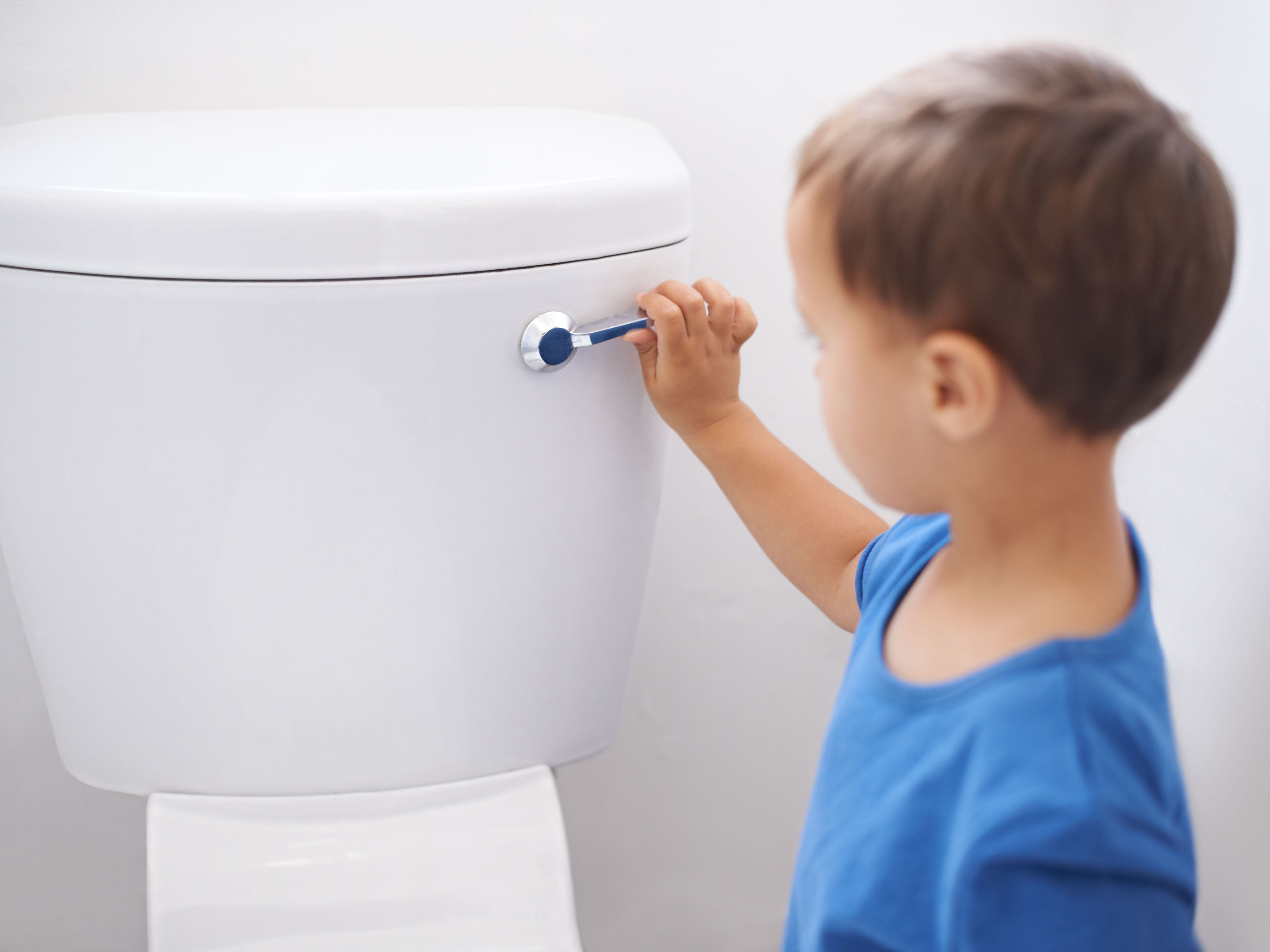 child flushing toilet