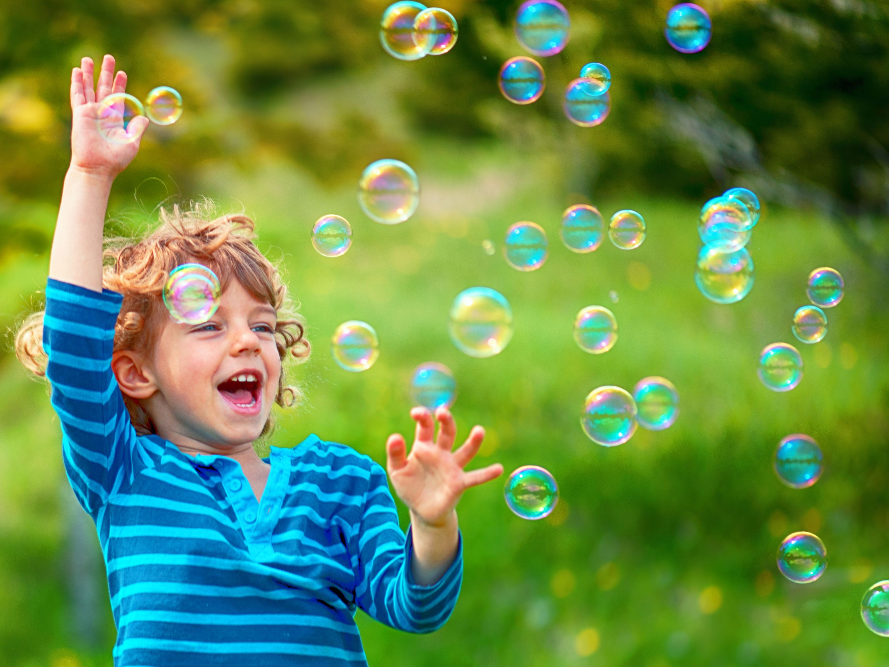 boy playing in bubbles